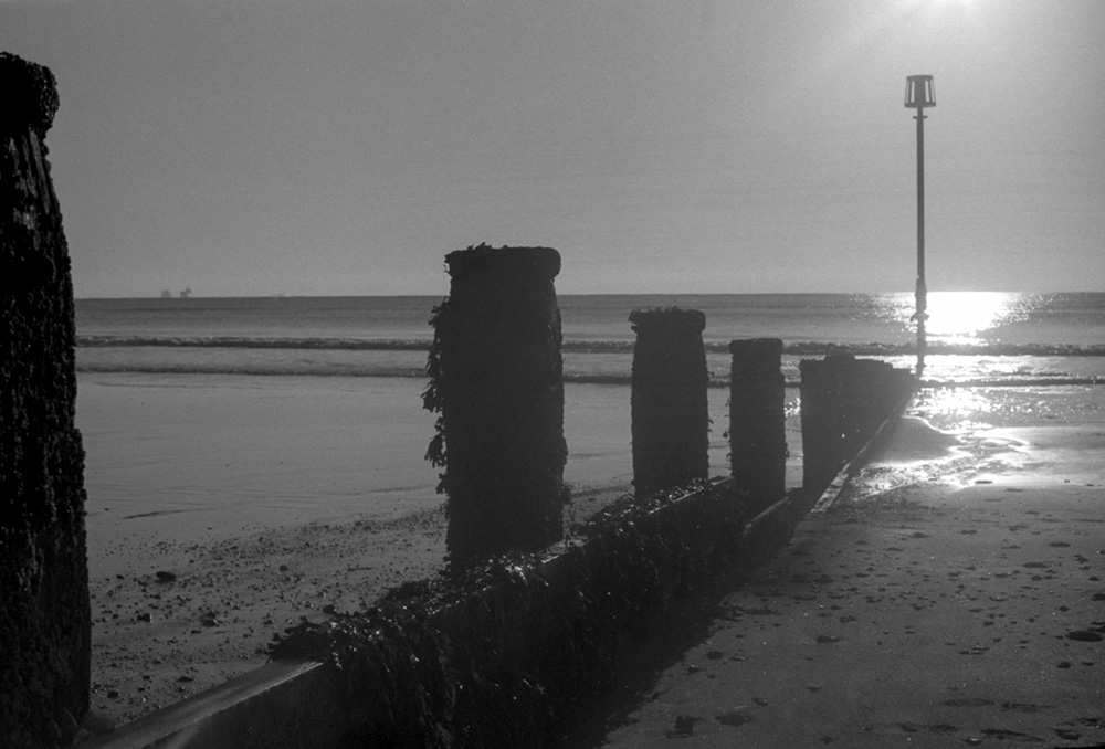 Groynes/posts running into the sea